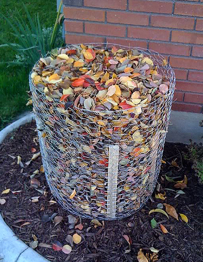 leaves stacked in a chicken wire cylinder