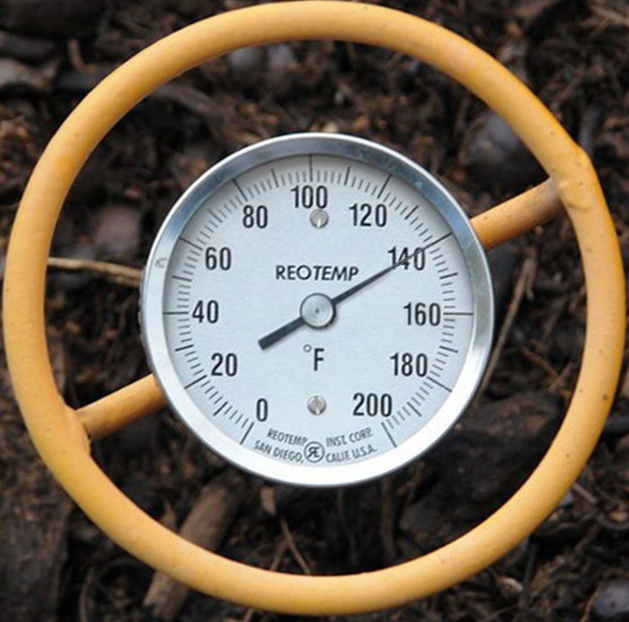 thermometer in the ground showing 140 degrees fahrenheit