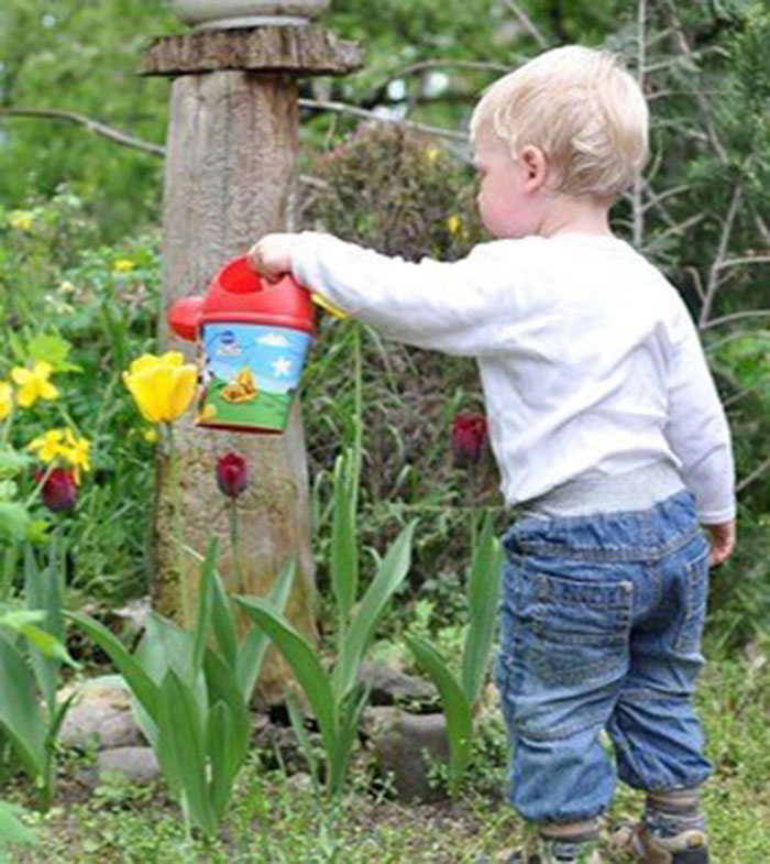 child watering flowers