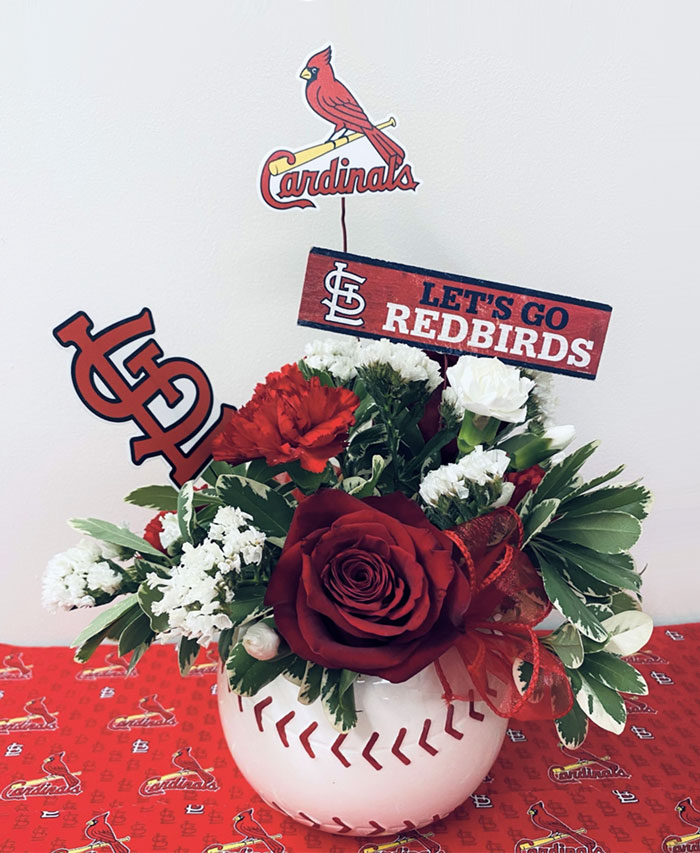 red flowers in a red vase with images of cardinals on a bats and STL