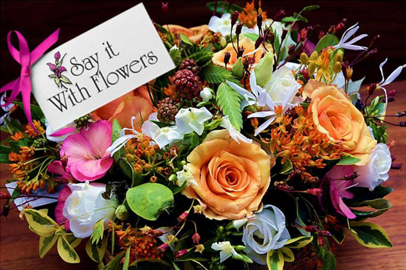 basket of flowers with note saying Say it with flowers