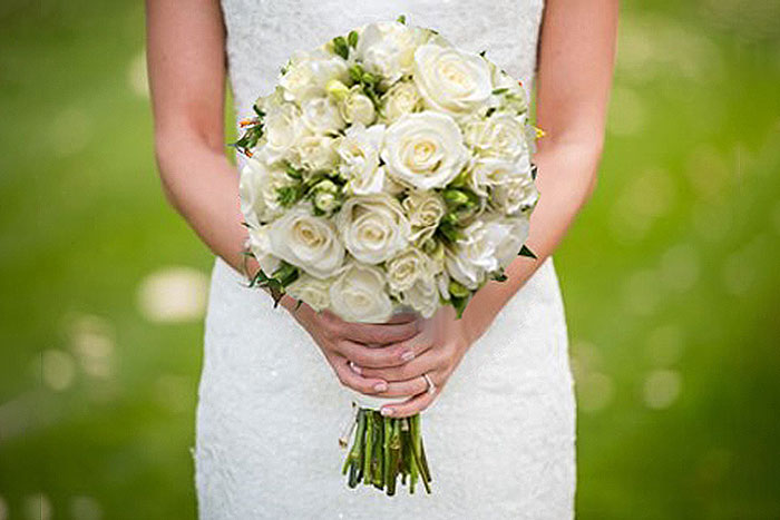woman with white flowers in a wedding dress