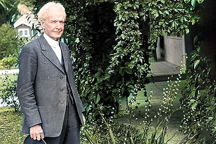 man standing in front of trellis with foliage