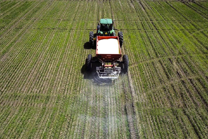 tractor spreading fertilizer