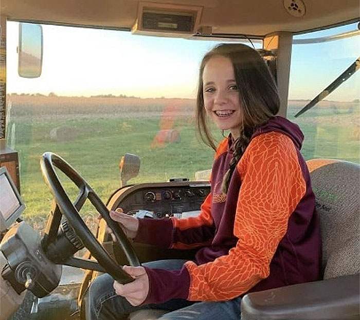 young girl driving tractor