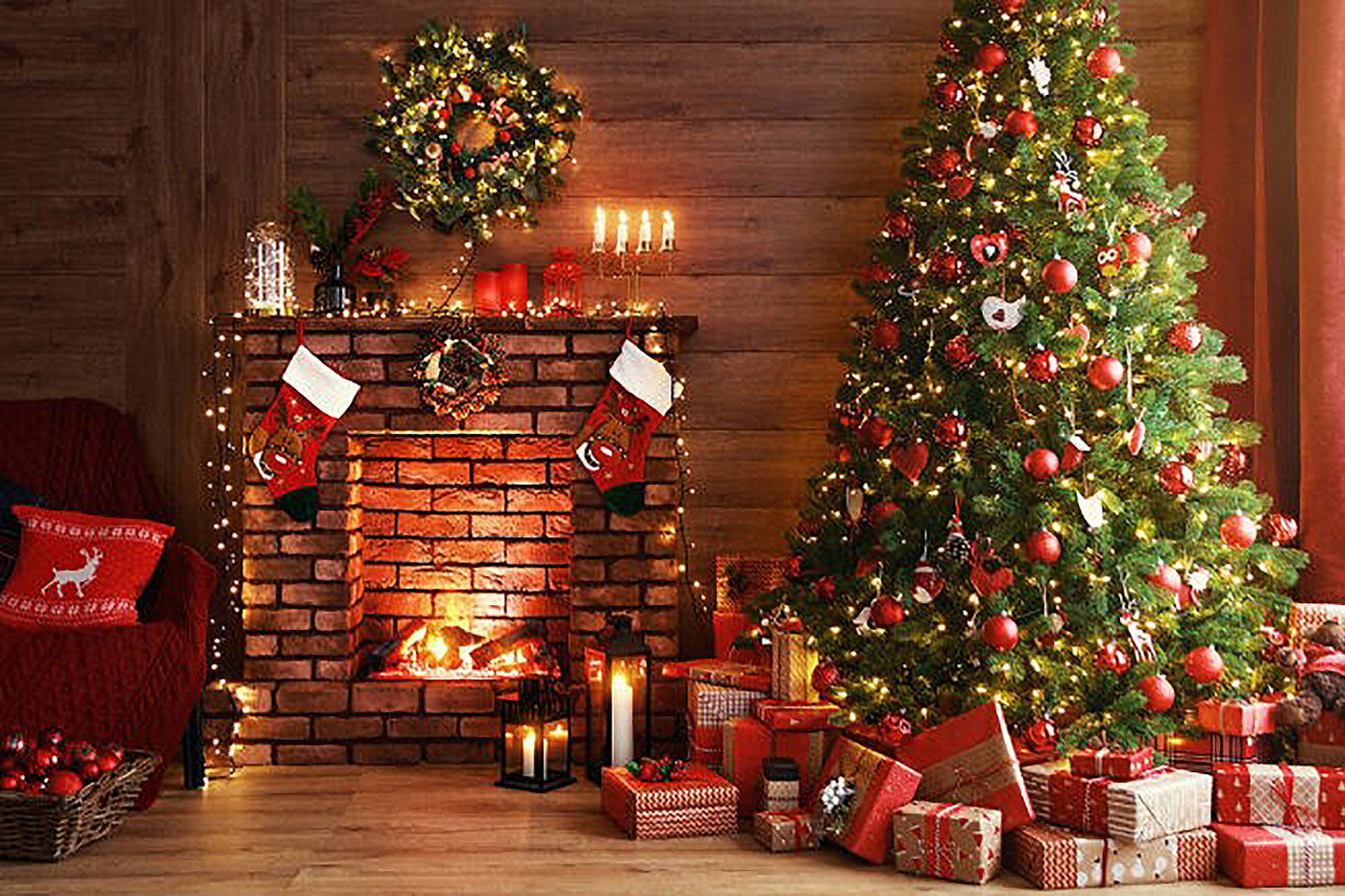 decorated evergreen tree next to fireplace in log house
