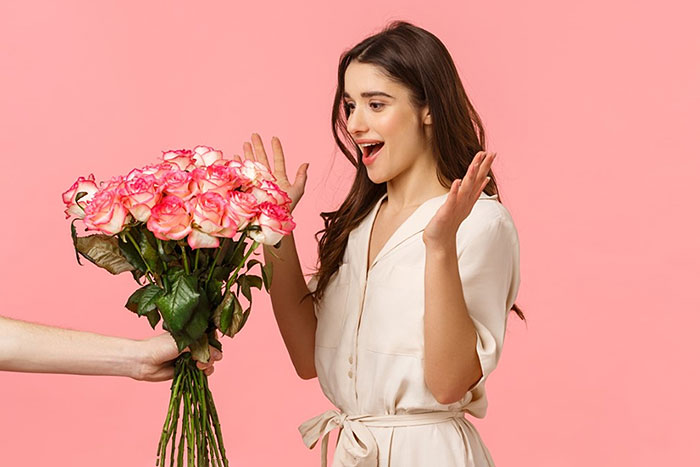 woman recieving pink flowers