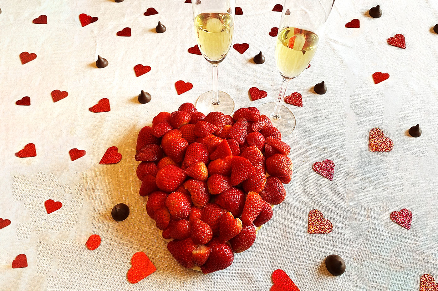 strawberries piled on a heart-shaped pie