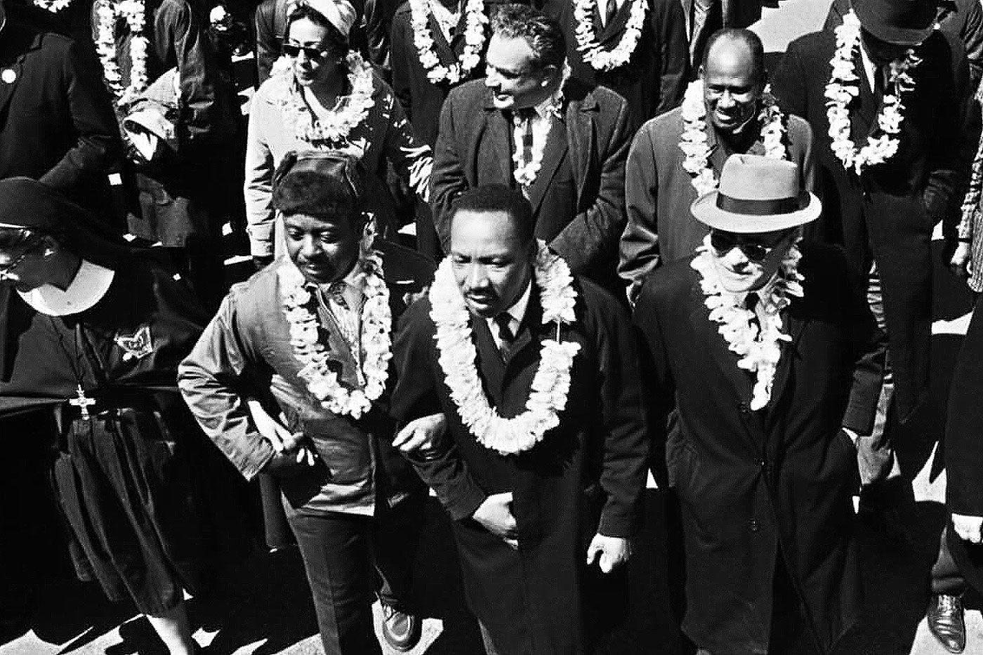 group of people marching with leis