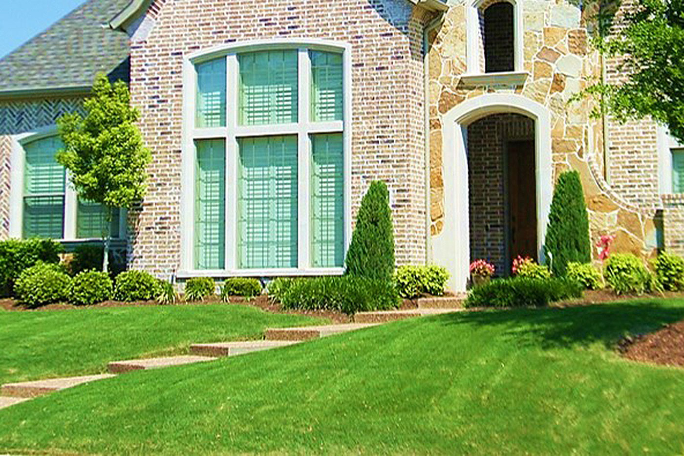 brick house with lawn