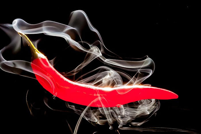 long red pepper with whisps of smoke